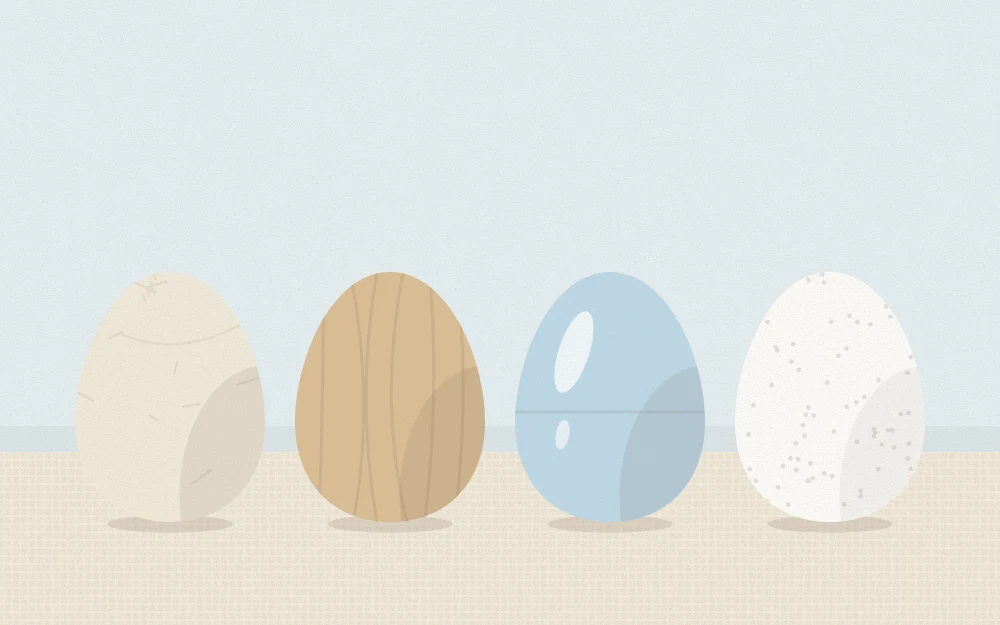 Four craft egg forms in a row: white paper mache, pale wood, smooth plastic and matte foam