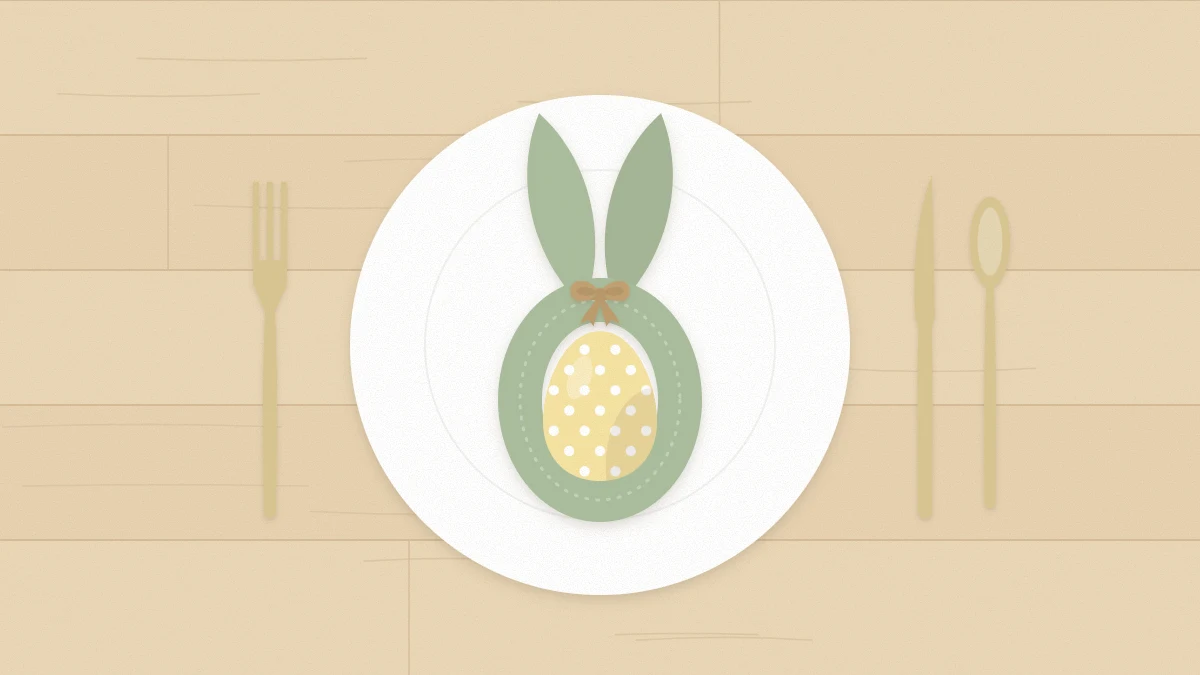 A napkin folded into two upright bunny ears tied with twine around an egg on a plate with cutlery