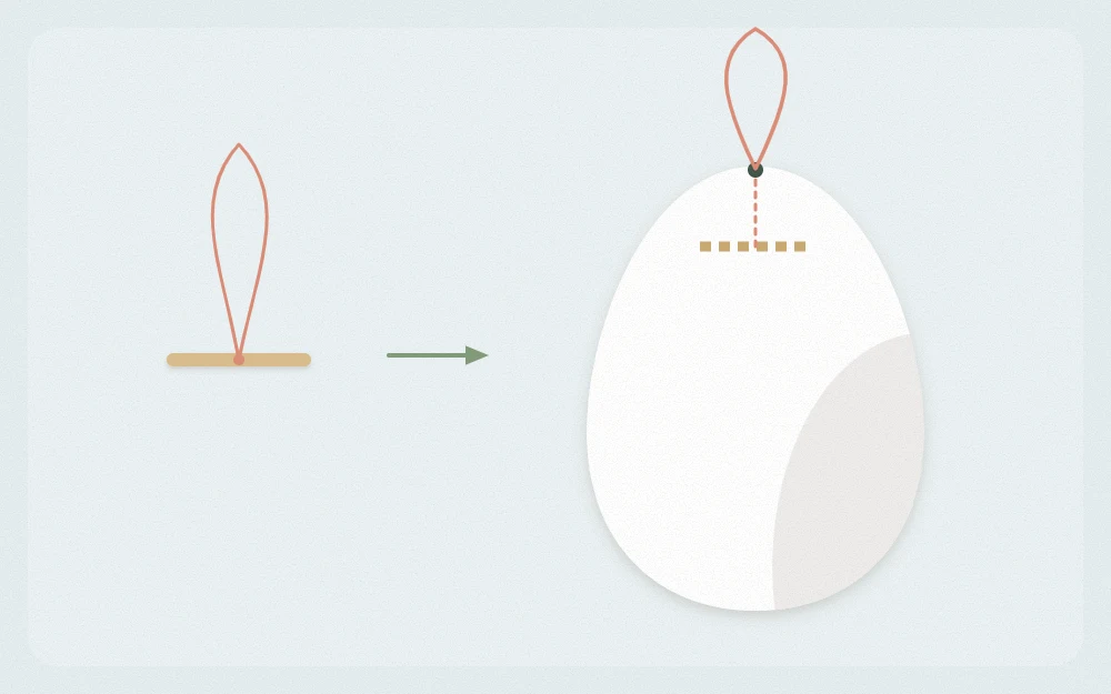 Blown egg with a thread loop tied to a short toothpick piece slipped through the top hole