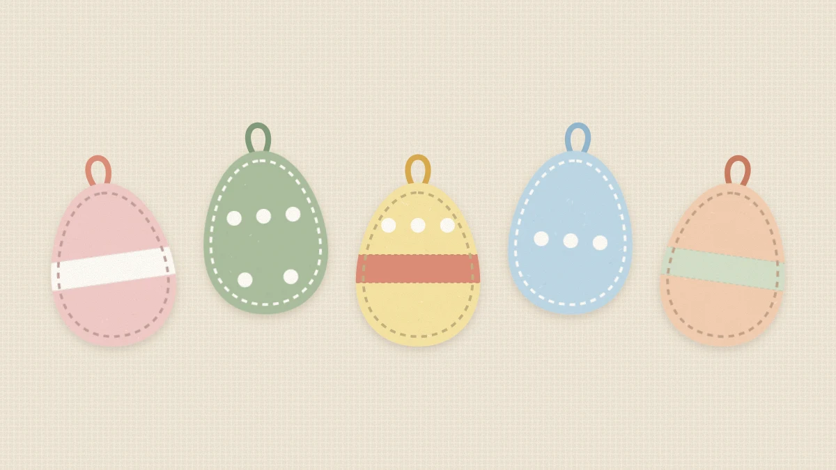 Five stuffed pastel felt eggs with stitched edges, bands, dots and ribbon loops laid out on a table