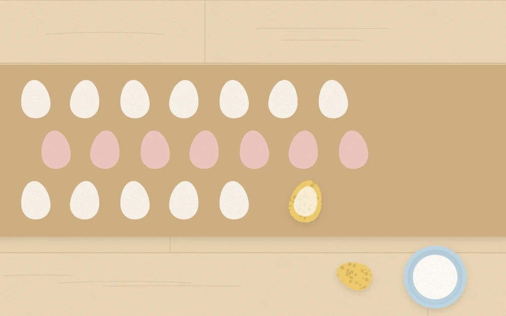 Kraft paper runner being stamped with rows of egg shapes using an egg-shaped sponge and paint