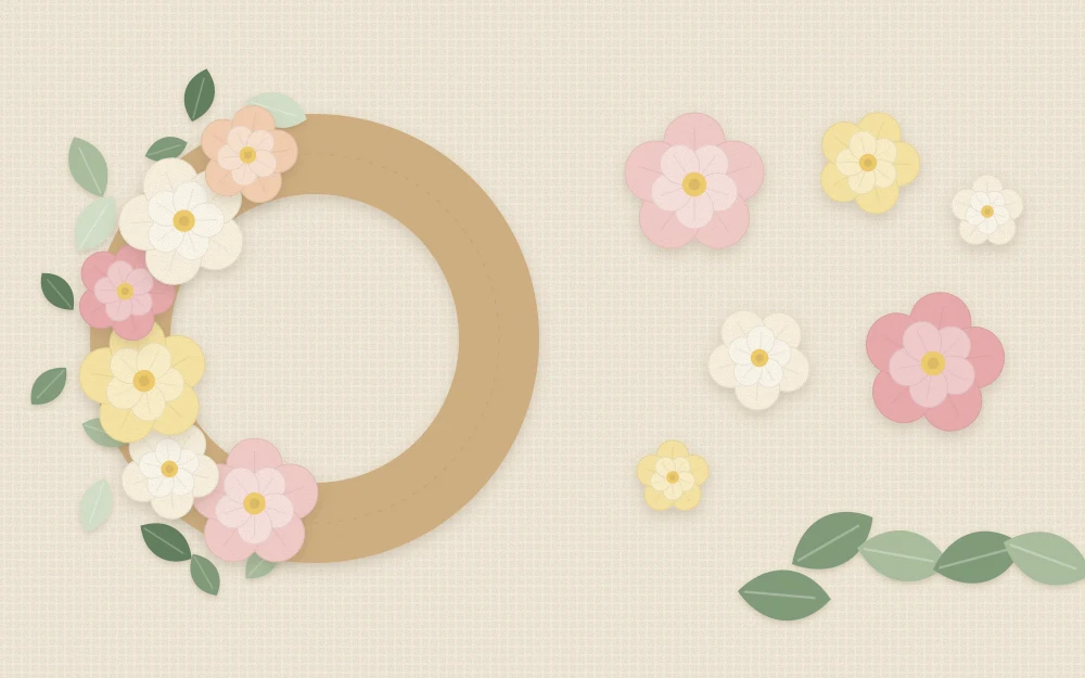 A flat cardboard ring partly covered with paper flowers, with loose flowers and leaves beside it