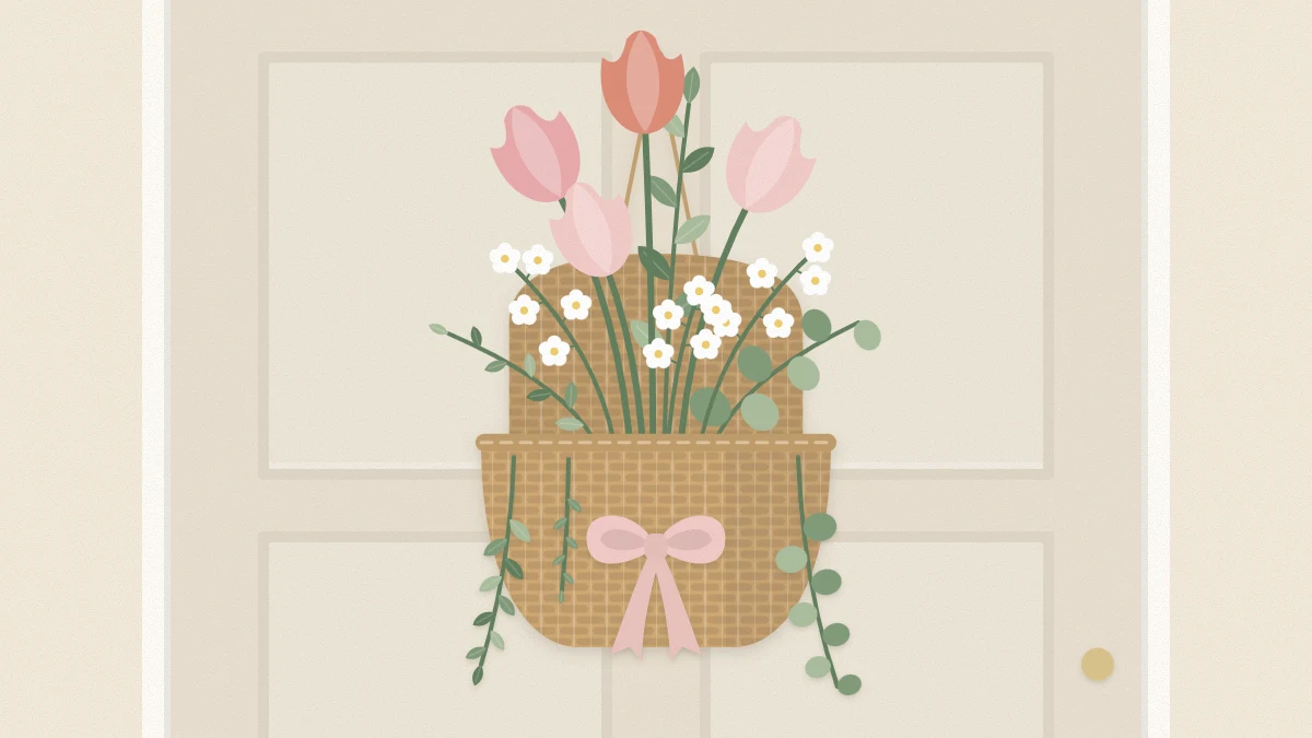 Flat-backed woven basket on a door filled with tulips, white flowers and trailing greenery, with a ribbon bow